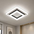 Square white LED ceiling light with black trim mounted in a modern room.