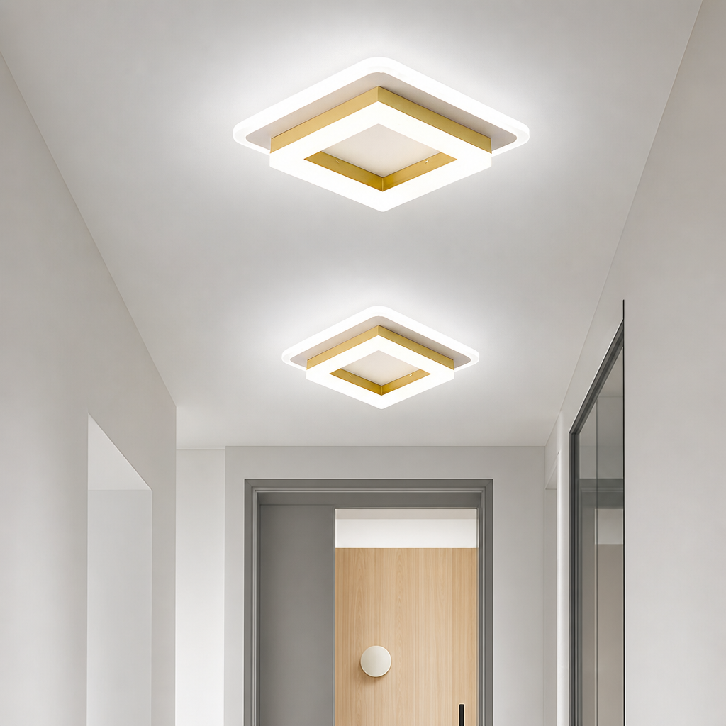 Two glowing square white and gold ceiling lights in a modern hallway.