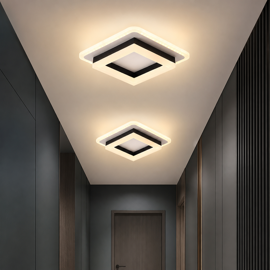 Two square black-and-white LED ceiling lights glowing warmly in a modern hallway.