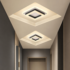 Two glowing square modern ceiling lights installed in a sleek hallway ceiling.