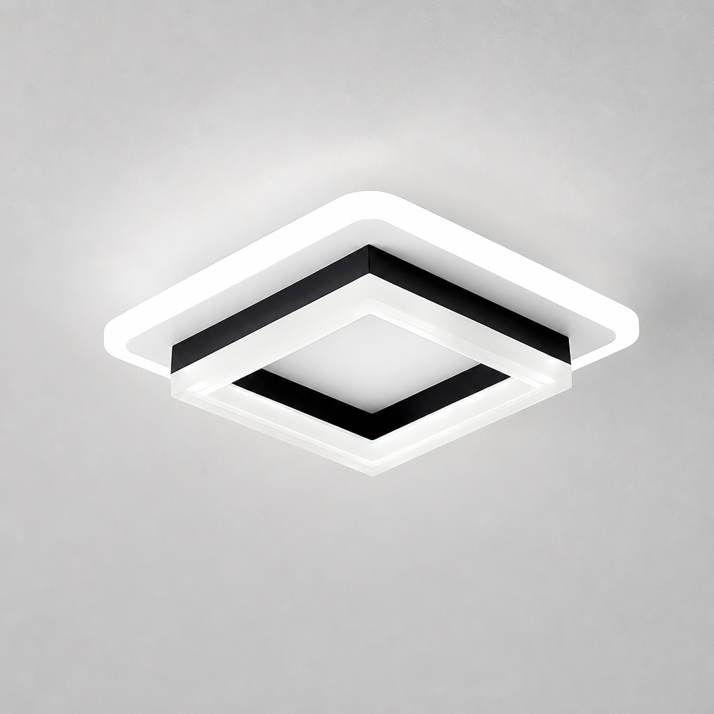 Square black and white ceiling light with a glowing white rim on a plain gray ceiling.