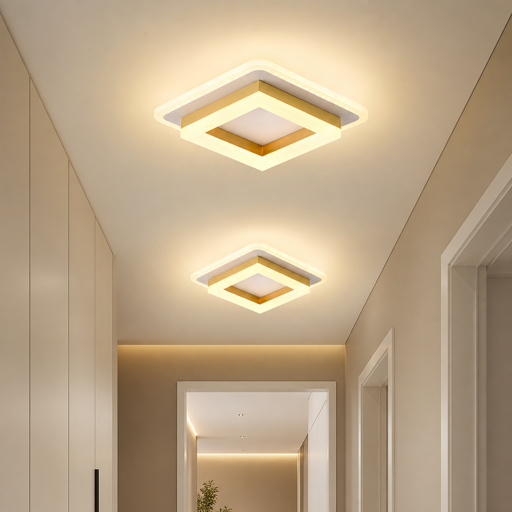 Two square gold and white ceiling lights glowing warmly in a modern hallway.