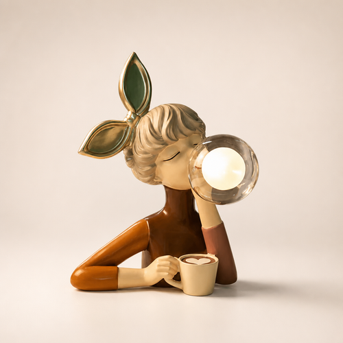 Stylized woman figurine with leaf headband blowing a glass bubble while holding a mug.