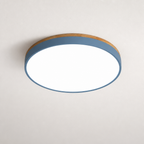 Round flush mount ceiling light with a blue-gray band and white glowing diffuser on a plain ceiling.