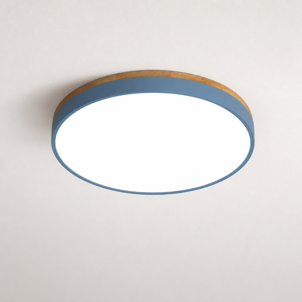 Round flush mount ceiling light with a blue-gray band and white glowing diffuser on a plain ceiling.