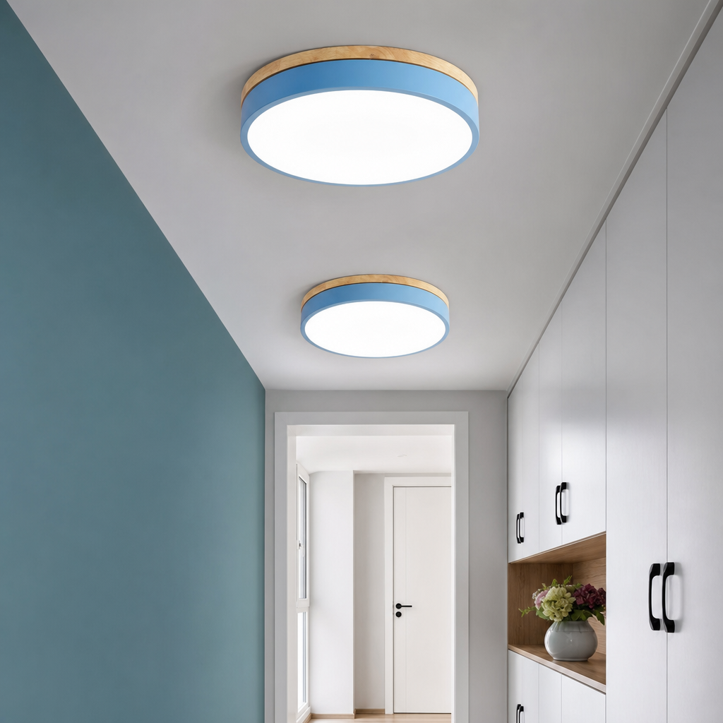 Two round blue and wood flush ceiling lights illuminating a modern hallway with cabinets.