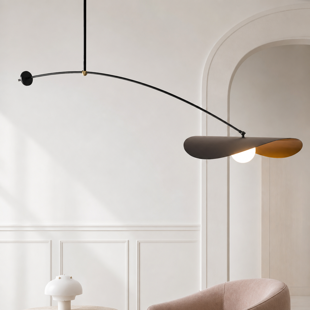 Modern mobile pendant light with curved black arm, sculptural brown blades, and a glowing bulb in a white room.