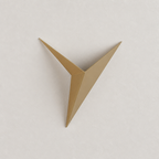 Gold angular origami bird wall decor centered on a pale textured wall.