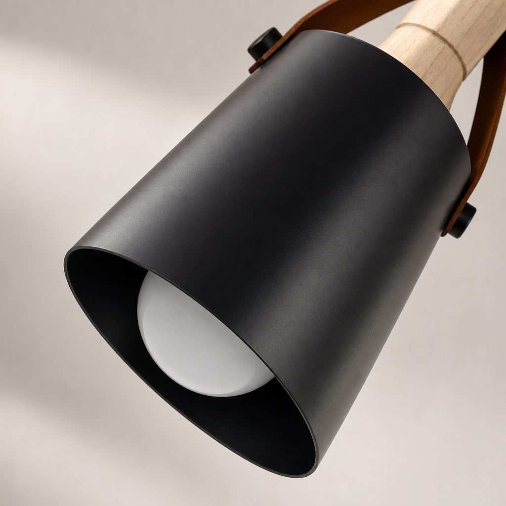 Black cylindrical pendant lamp shade with wood detail and visible white bulb.