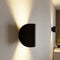 Black curved wall light with warm up-and-down lighting
