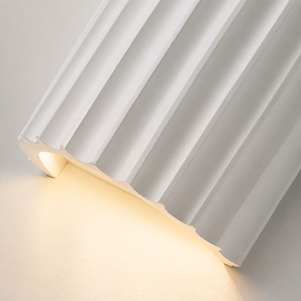 White pleated curtain pooling softly on a warm glowing floor.