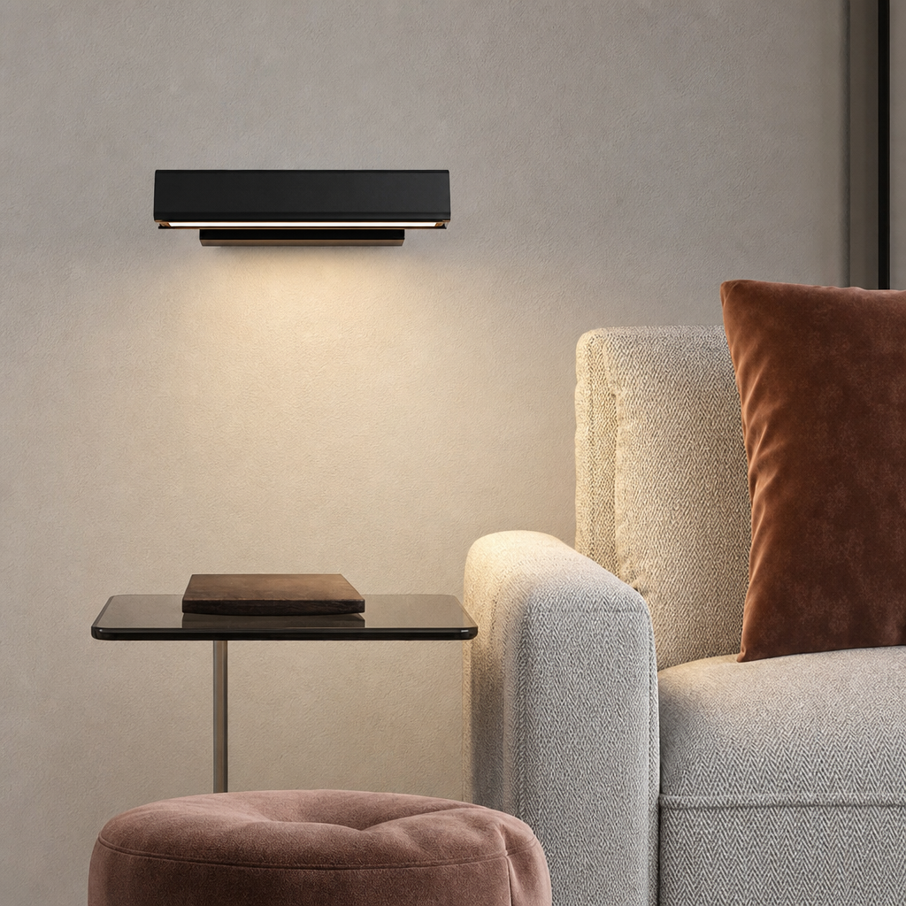Black rectangular wall light above a side table beside a beige armchair with a brown cushion.