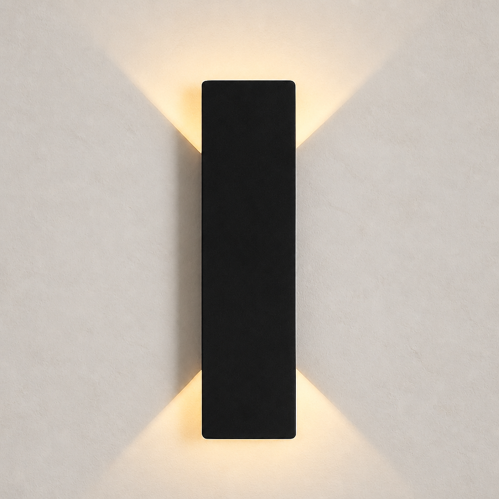 Black rectangular wall sconce casting warm light upward and downward on a plain wall.