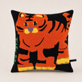 Black square cushion with a tufted orange cartoon tiger design on the front.