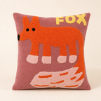 Pink square fox pillow with orange fox design and yellow FOX lettering.