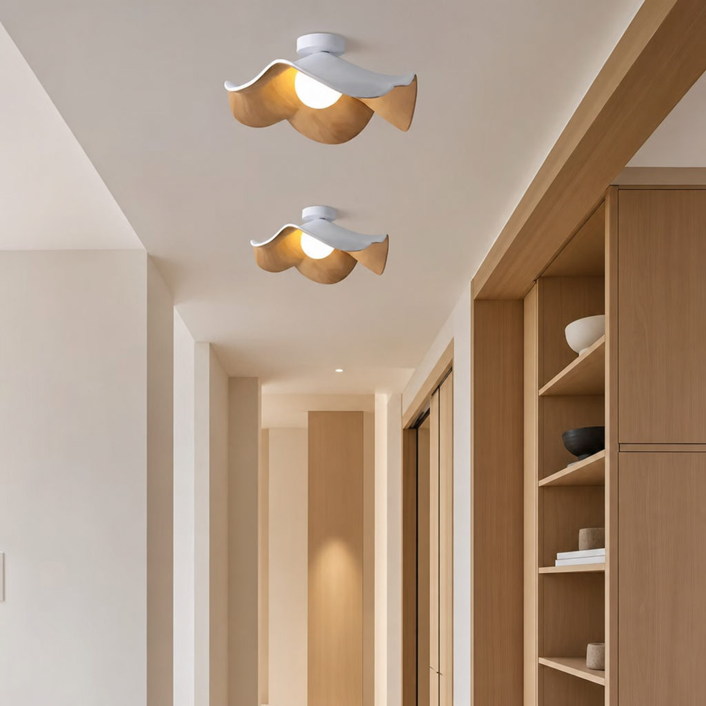 Two sculptural white and wood ceiling lights glowing in a modern hallway.