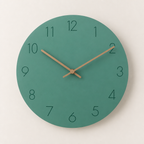 Teal round wall clock with dark numerals and wooden hands on a light neutral background.