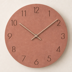Round terracotta wall clock with black numerals and pale hands.
