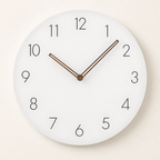 Round white wall clock with black numerals and slim brown hands centered on a light background.