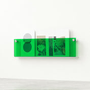 Translucent green wall-mounted magazine rack holding books and postcards.