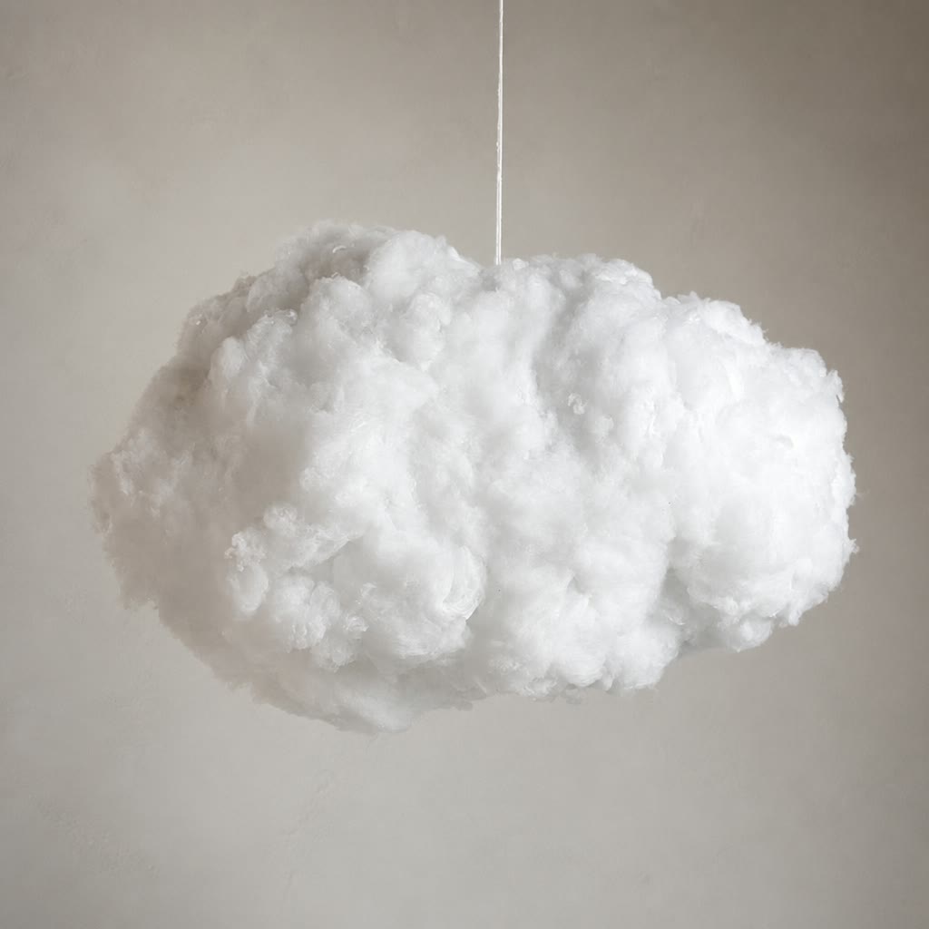 Fluffy white cloud pendant suspended by a thin cord against a soft gray wall.