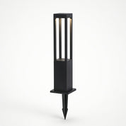 Black rectangular outdoor stake light with vertical glowing panels and pointed ground spike.