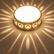 Glowing round beige decorative lamp casting warm petal-shaped light patterns.