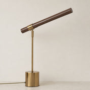 Brass and wood desk lamp with cylindrical base and angled wooden tube shade.