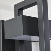 Matte black metal frame with rectangular panels and open cutouts.