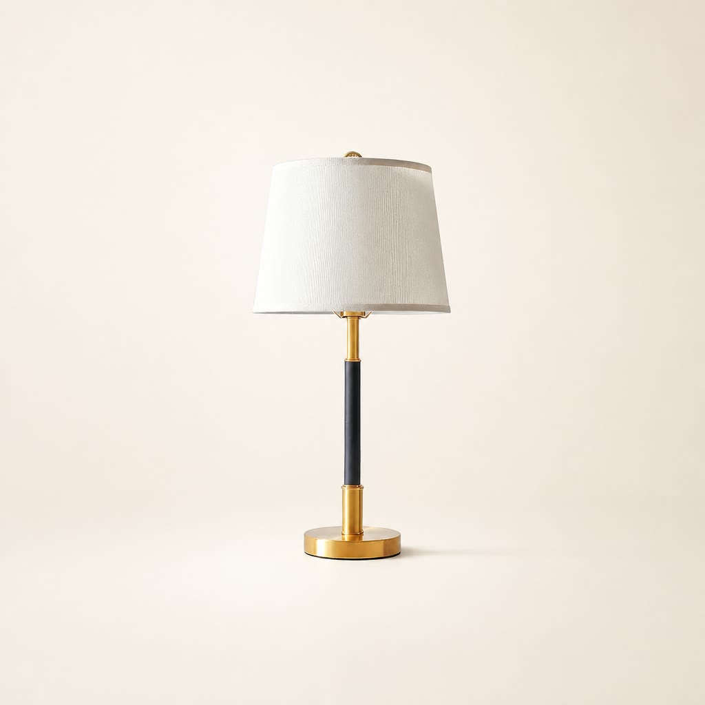 White shade table lamp with a black stem and polished gold base.