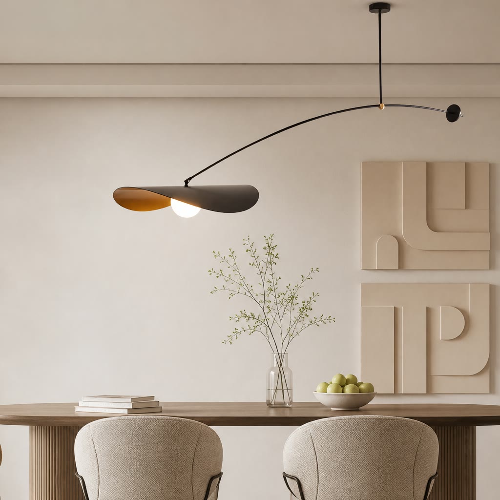 Modern black and wood pendant light above a dining table with minimalist wall art.
