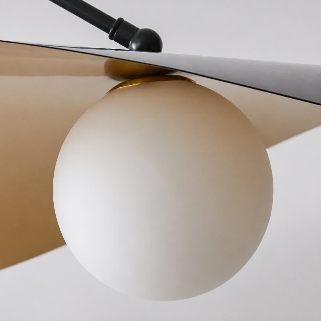 White spherical pendant light beneath a curved beige shade with a black mounting rod.