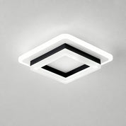 Square black and white ceiling light with a glowing white rim on a plain gray ceiling.