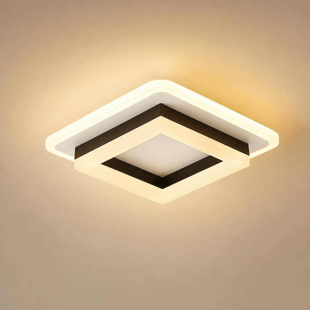Square warm ceiling light with layered white frame and black inner trim glowing on a beige background.