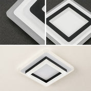 Square white and black acrylic ceiling light fixture with layered diffuser panels.
