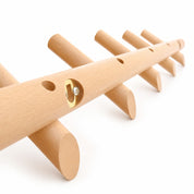 Light wooden wall rack with rounded pegs and a small metal mounting plate.