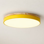 Round yellow ceiling light with wood trim and glowing white diffuser.
