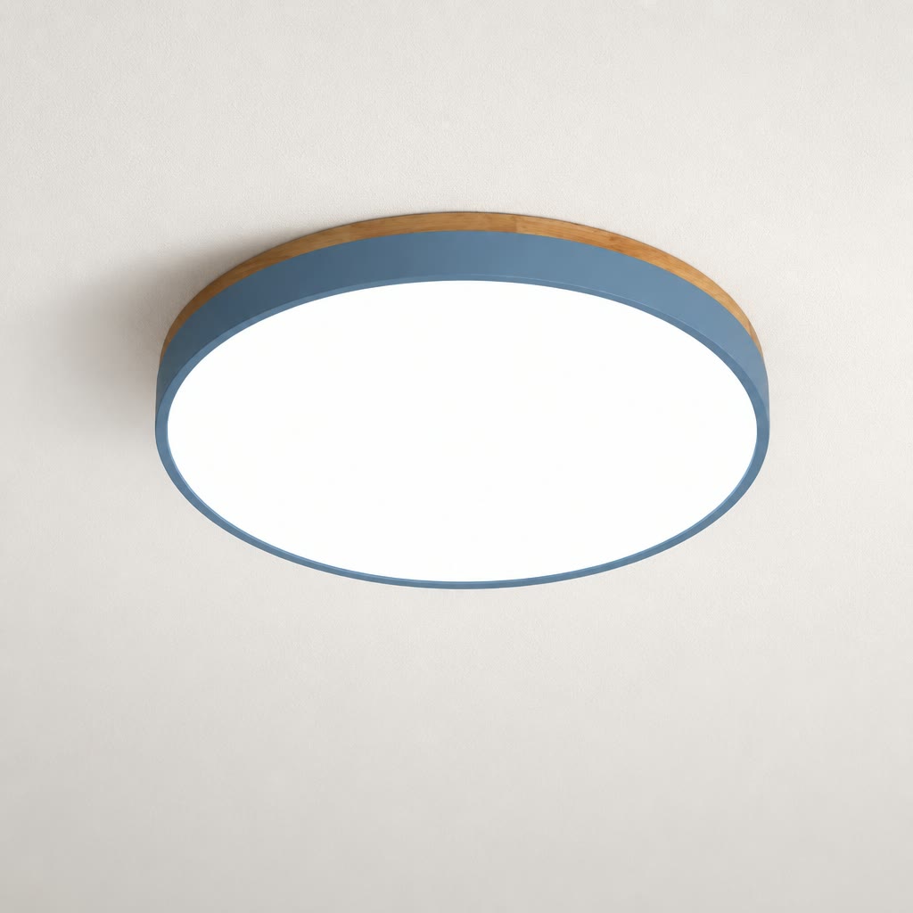 Round flush mount ceiling light with a blue-gray band and white glowing diffuser on a plain ceiling.