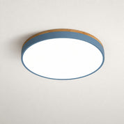 Round flush mount ceiling light with a blue-gray band and white glowing diffuser on a plain ceiling.