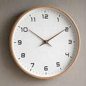 Round wall clock with a wooden rim, white face, black numerals, and brown hands.
