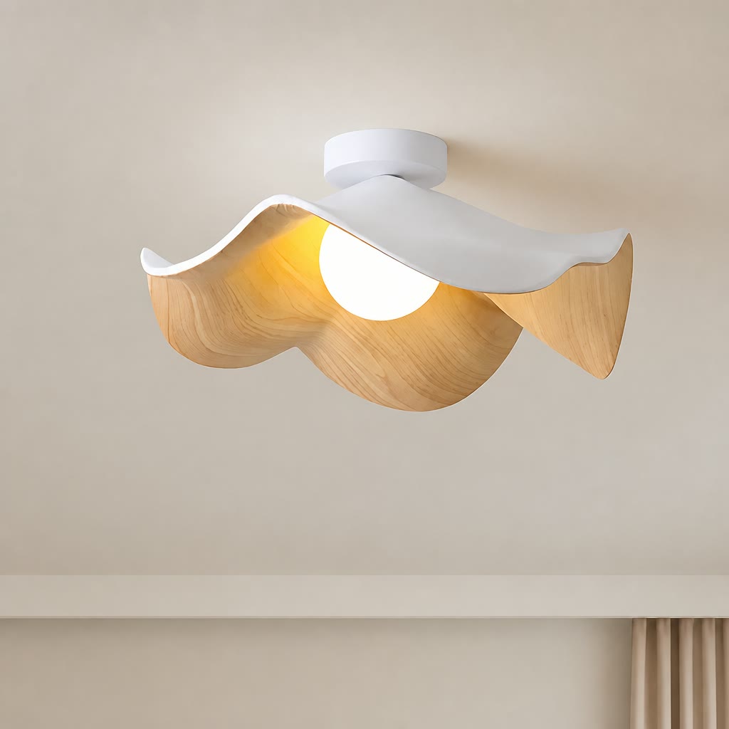 Wavy white and wood ceiling light with a glowing round bulb mounted on a neutral ceiling.