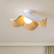 Wavy white and wood ceiling light with a glowing round bulb mounted on a neutral ceiling.