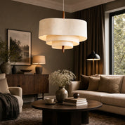 Tiered cream fabric pendant light hanging above a warm neutral living room.