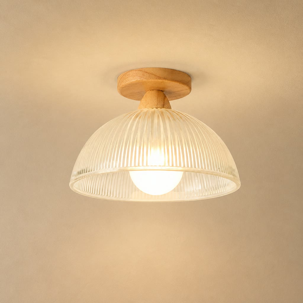 Warm wood flush mount ceiling light with a cream ribbed dome shade and glowing bulb.