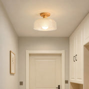 Wood and woven cream semi-flush ceiling light glowing in a cozy hallway.
