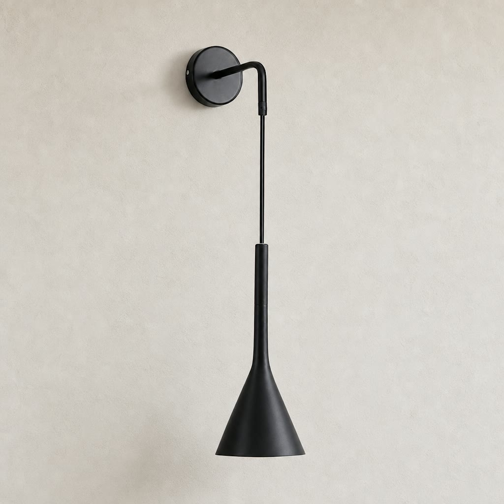 Black wall-mounted sconce with round backplate and tapered cone shade on a light wall.