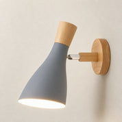 Gray wall sconce with wooden accents and a warm glowing shade.