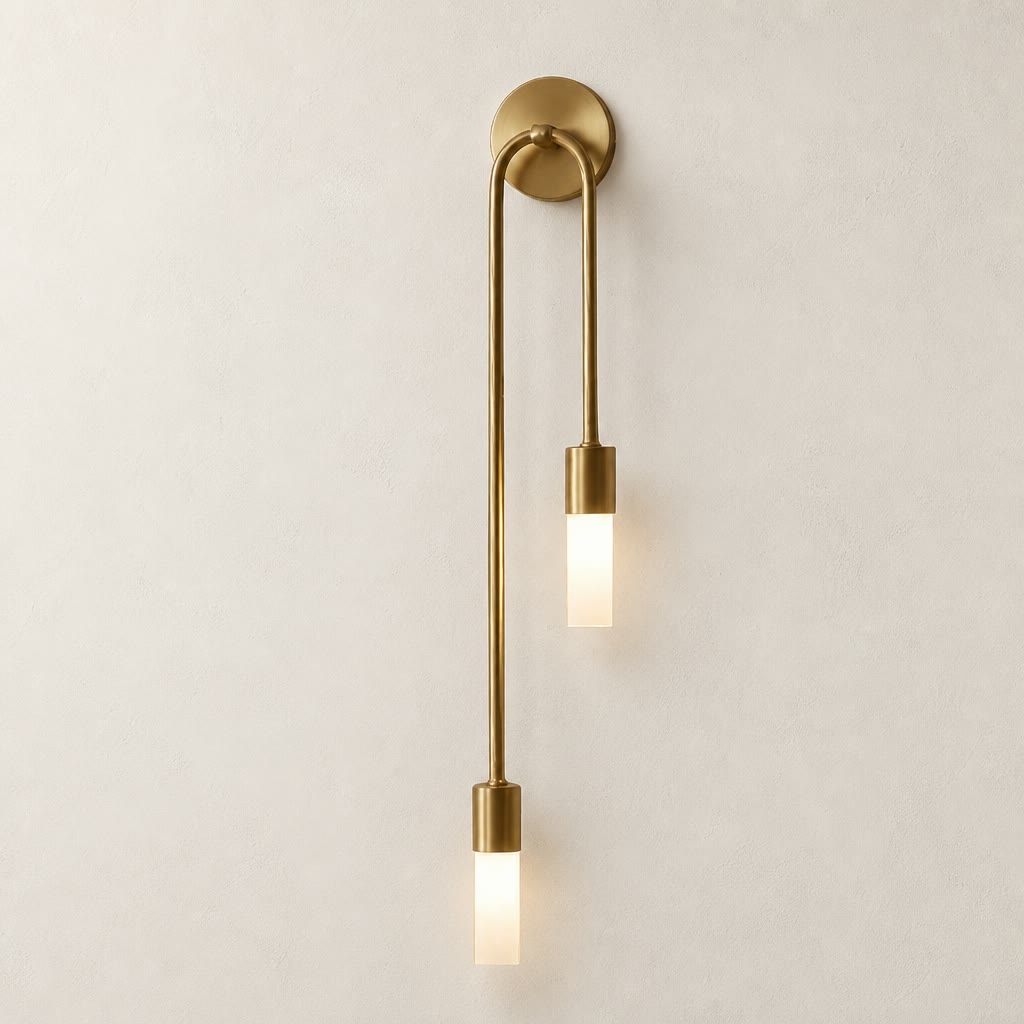 Brass double pendant wall sconce with two glowing frosted rectangular shades.