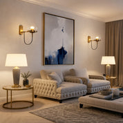 Tufted beige lounge chairs and matching ottoman in a softly lit luxury living room.