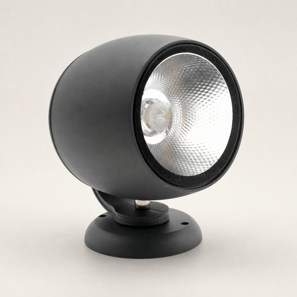 Black cylindrical spotlight with silver reflector on a round mounting base.